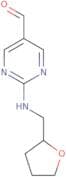 2-[(Tetrahydrofuran-2-ylmethyl)amino]pyrimidine-5-carbaldehyde