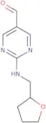 2-[(Tetrahydrofuran-2-ylmethyl)amino]pyrimidine-5-carbaldehyde